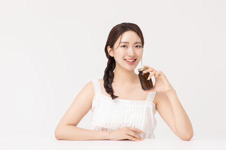 A young woman taking nutritional supplements for her health