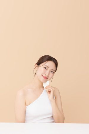 Portrait of a young woman massaging her skin using gua shaの写真素材