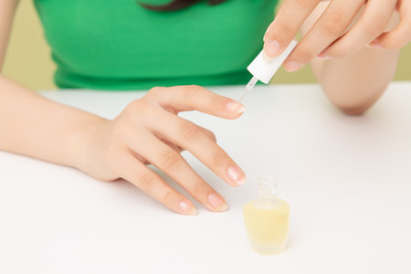 Woman's hands applying nail nourishmentの写真素材