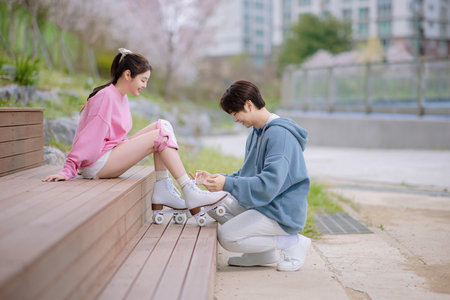 Couple skating in the parkの写真素材