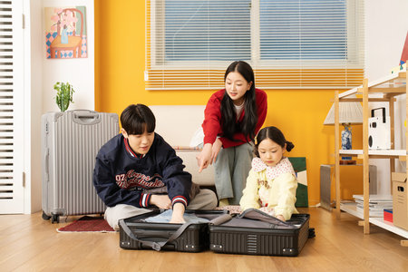 A family unpacking their suitcases at their accommodationの写真素材