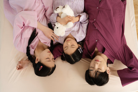 Portrait of a family lying in bedの写真素材