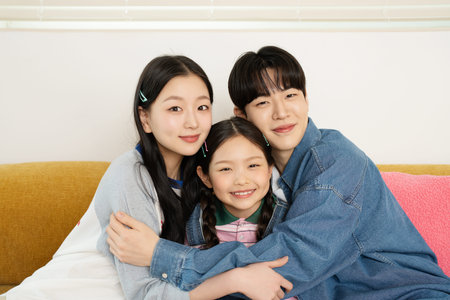 A harmonious family sitting on the sofa and hugging