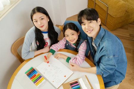 A family coloring togetherの写真素材