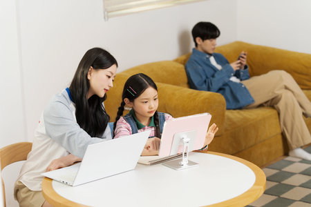 A family gathered in the living room doing their own thing