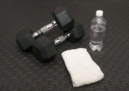 Arm Weights, Sweat Towel And Water Bottle On Workout Rubber Matの写真素材