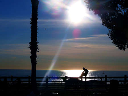 Silhouette of Man Playing Guitar By the Seaの写真素材