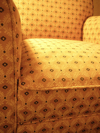 Yellow patterned overstuffed chair viewed from an extreme perspectiveの写真素材