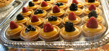 Individual Miniature Berry Tart Pastries in Bakery Display