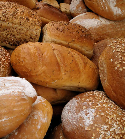 Variety of Fresh Baked Loaves of Gourmet Bread in Bakeryの写真素材
