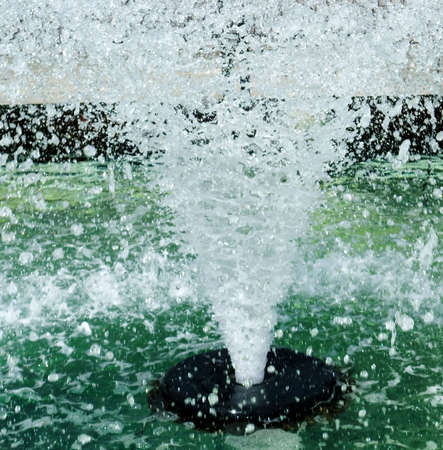 Abstract Closeup of Public Fountain with High Spray of Green Waterの写真素材