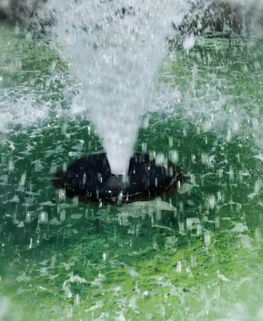 Abstract Closeup of Public Fountain with High Spray of Green Waterの写真素材