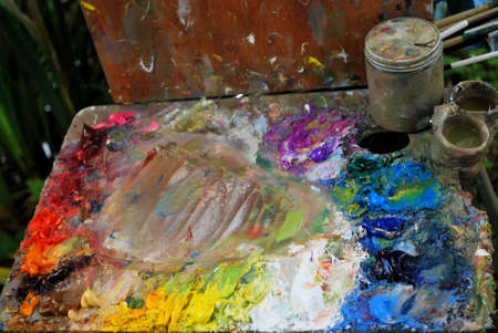 Painter Palette with Stains of Oil Paint on Easelの写真素材