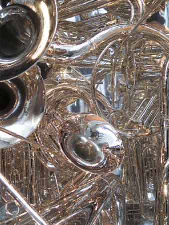 Many brass horns in a tangle: tubas, trombones, trumpets, and bugleの写真素材