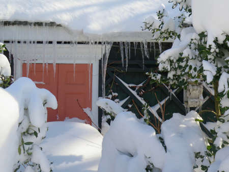 Detail of front door of house blocked by pile of snow after snowstormの写真素材