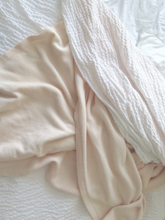 Detail of bed with set of white morning beddingの写真素材