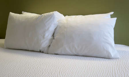 Detail of bed with set of white morning beddingの写真素材