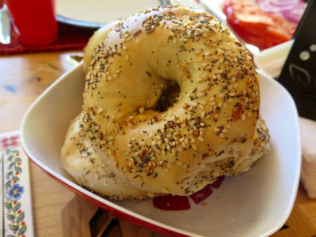 Bowl of everything bagels displayed on breakfast tableの写真素材