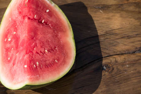 Watermelon on wooden quarter cutの写真素材