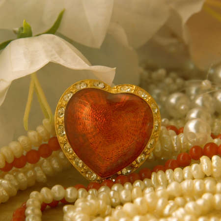 ruby red heart with rhinestones, pearls and white bellflowersの写真素材