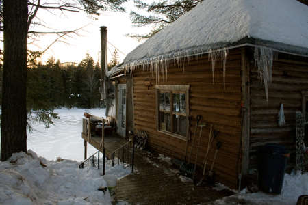 Cabin on lake in winterの写真素材