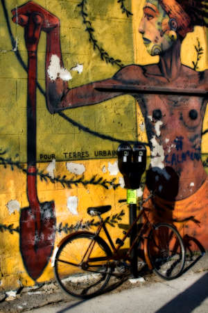 Bicycle by wall with muralの写真素材