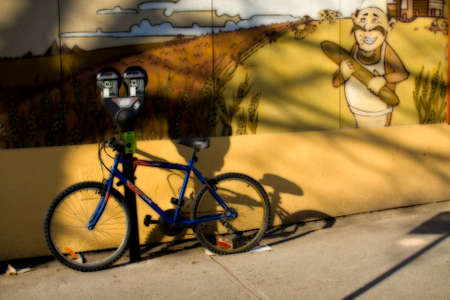 Bicycle by wall with muralの写真素材