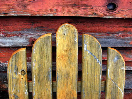 Weathered wood detail of chair by wallの写真素材