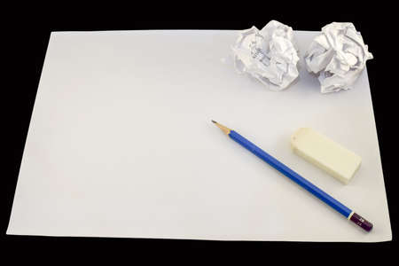 Drawing paper with pencil, rubber and two crumpled paper balls.の写真素材