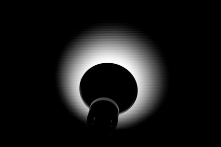 Back lamp lighting to the white wall in the dark.の写真素材