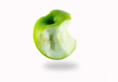 Isolated half eaten green apple on the white background.の写真素材