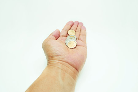 Close up coins  in bare hand, donate or receive coins.の写真素材