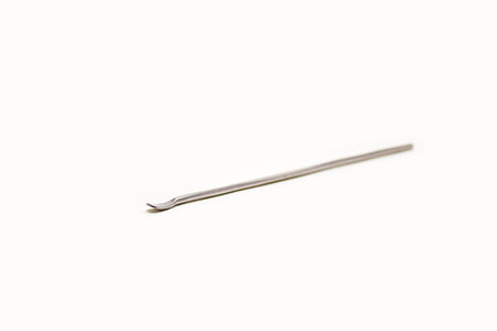 Isolated metal ear pick on white background, ear wax removal tool.の写真素材