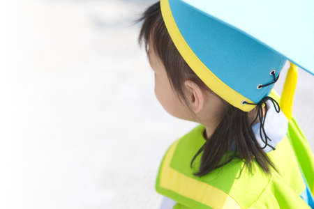 Kid graduated from preschool waring suit from side view.の写真素材
