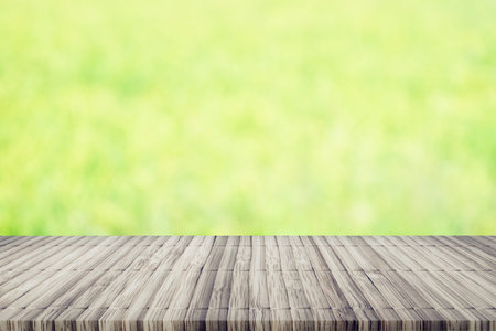 Empty perspective brown plank wooden board mock up display shelf with abstract beautiful nature blur...