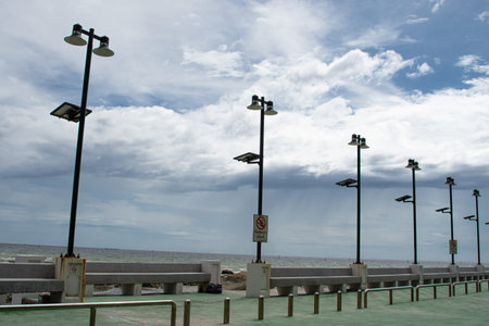 Solar cell street light and stainless steel fence on beach.