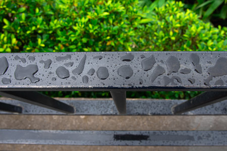 Steel safety rail on the blur leaves background.の写真素材