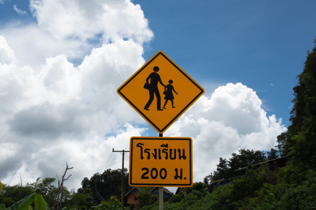 School zone sign on sky and mountain background.の写真素材