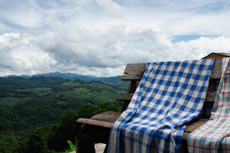 loincloth on wooden chair on sky and mountain background.の写真素材
