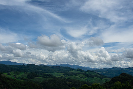 Green mountains and beautiful sky clouds under the blue sky. Natural landscape.の写真素材