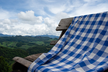 loincloth on wooden chair on sky and mountain background.の写真素材