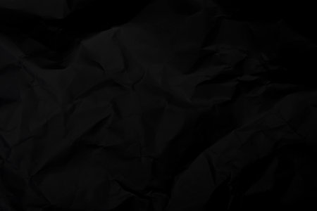 Black crumpled paper texture background. Black wrinkled paper texture background. Black crease fabric texture background. Black wrinkled fabric texture background.の写真素材