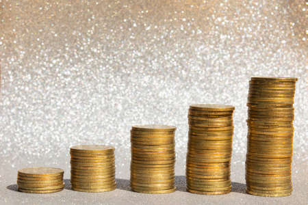Gold coins stacks on silver carborundum background, Concept saving money for the future, Stock Market Concept, Growing up business concepts.の写真素材