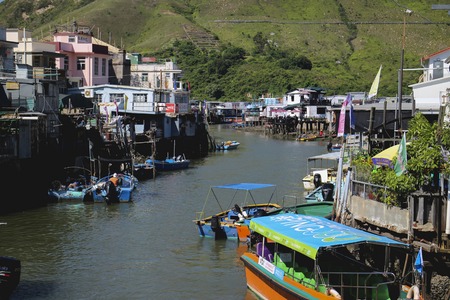 Village built above the waters in Lantau Island with boats parked along the housesのeditorial素材