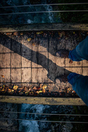 standing on a wooden rope bridgeの写真素材