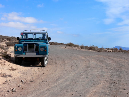 A 4WD pickup truck parked at a desert country road