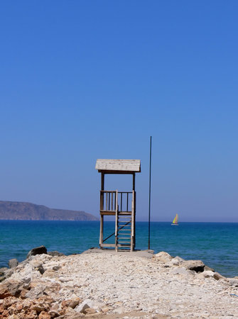 A lonely life guard tower on a stony beach looking out over the open sea - Creet in Greeceの写真素材