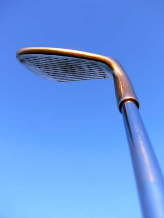 A golfclub held up against the blue skyの写真素材