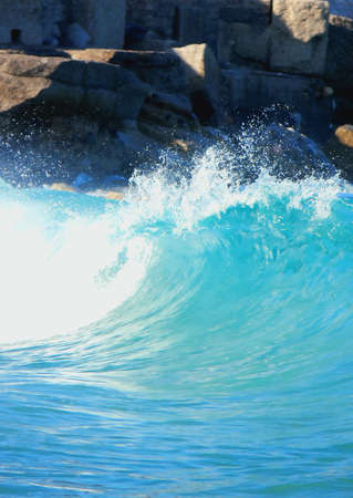 A wave curling just before it hits the shoreline in Sicilyの写真素材