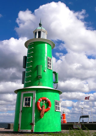 The green and red lighthouse in the harbour of Helsingör Denmark の写真素材